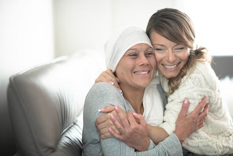 Cancer survivor and her daughter hugging.